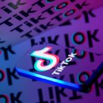 The TikTok logo is displayed on a smartphone screen in this photo illustration.